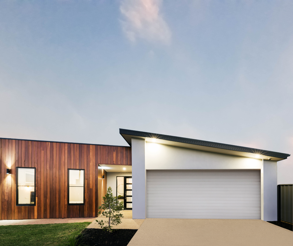 A modern house front view of garage and front door.