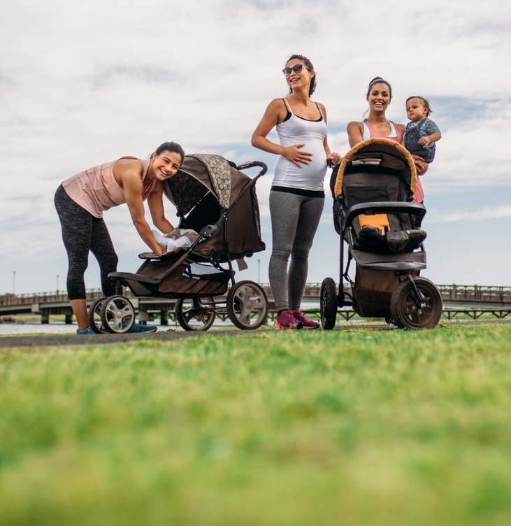 Three women, two with prams and babies, one pregnant.